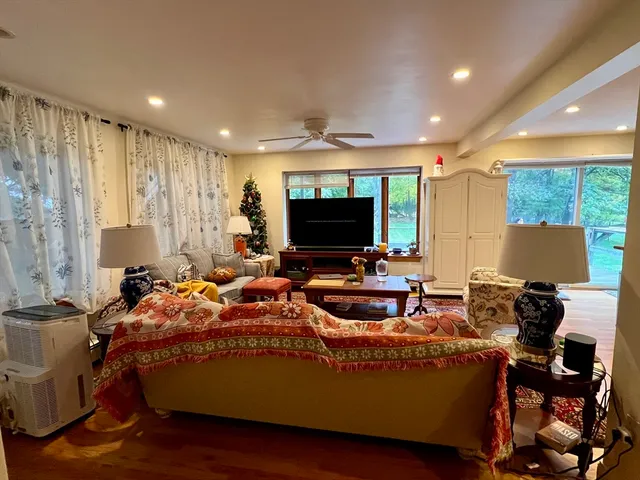 a living room with furniture and a flat screen tv