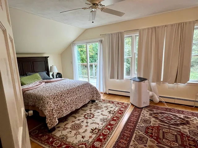 a bedroom with a large bed and a window