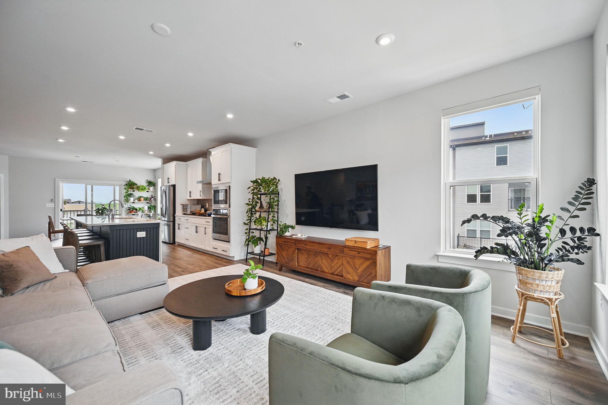 44623 Wolfhound Square Ashburn, VA 20147 - Photo 5 of 29 a living room with furniture and a flat screen tv