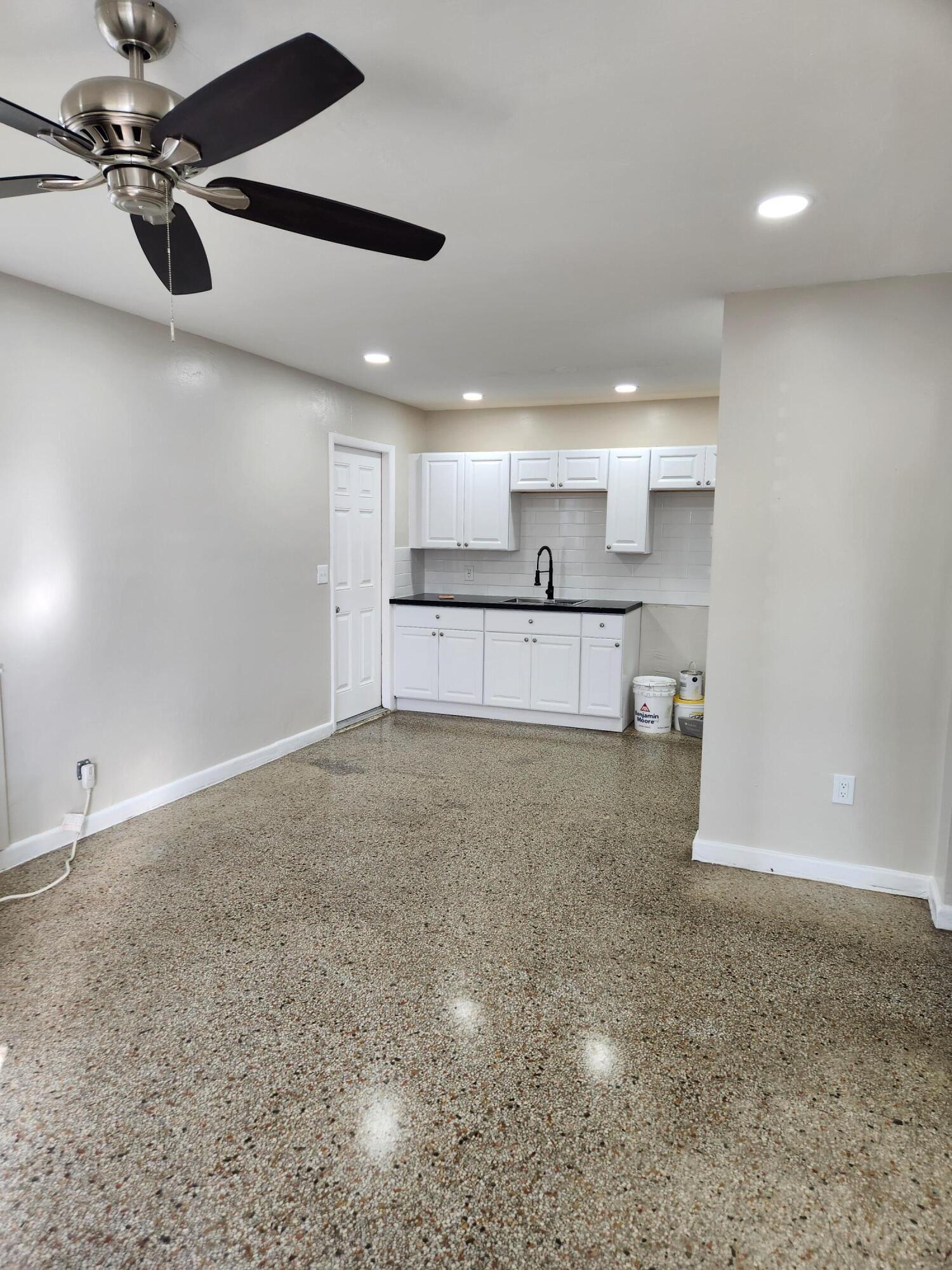 136 West 34th Street, Unit A Riviera Beach, FL 33404 - Photo 12 of 12 a view of a kitchen with a sink and chandelier fan