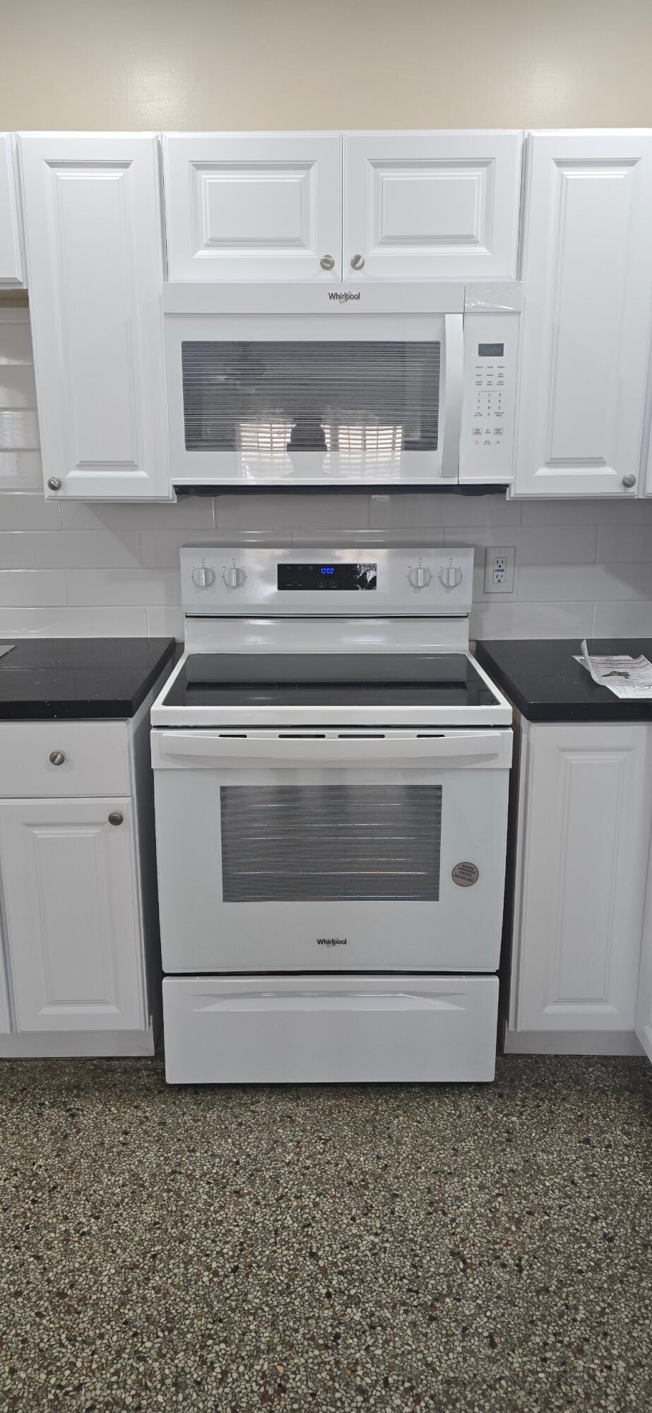 136 West 34th Street, Unit A Riviera Beach, FL 33404 - Photo 4 of 12 a stove top oven sitting inside of a kitchen