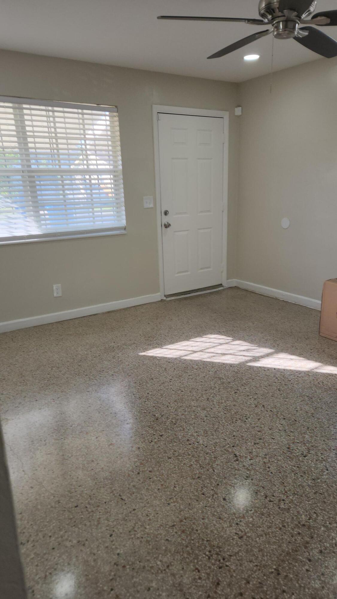 136 West 34th Street, Unit A Riviera Beach, FL 33404 - Photo 10 of 12 an empty room with a empty space and windows