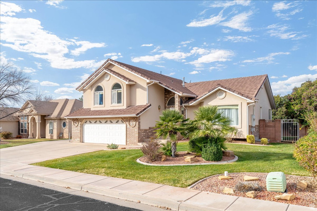 7 Reflection Way St. George, UT 84770 - Photo 3 of 54 Mediterranean / spanish-style house with an attached garage, driveway, a tile roof, and stucco siding