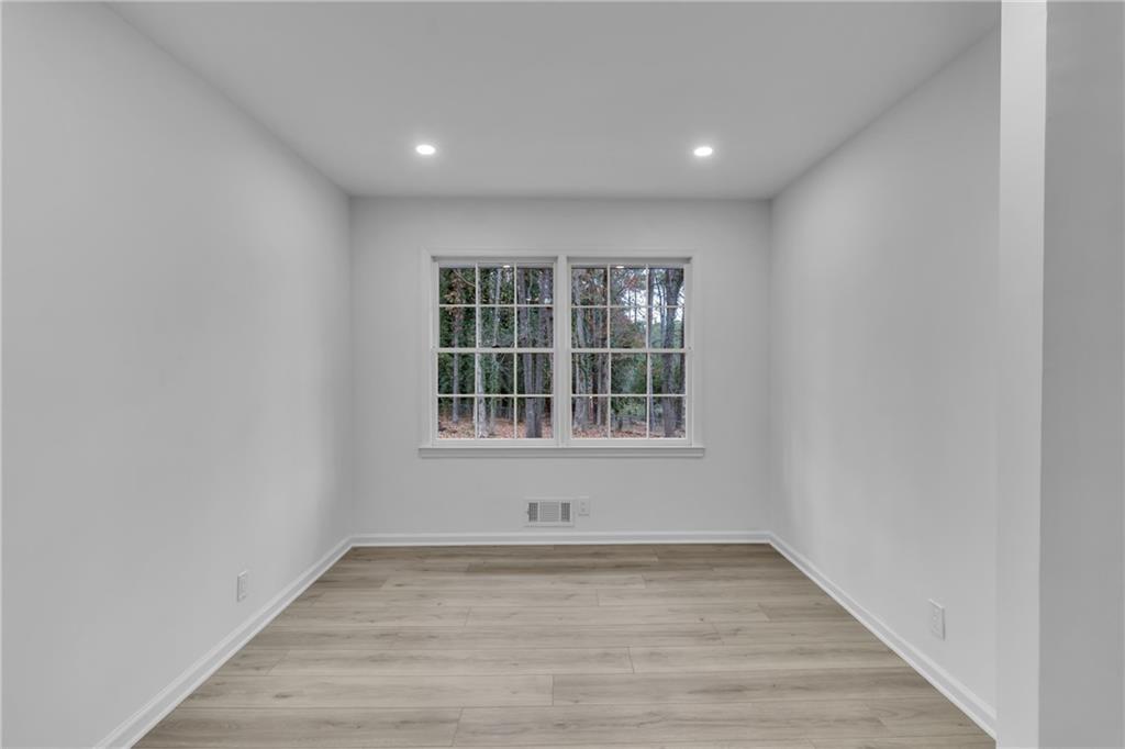 3296 Columbia Woods Drive Decatur, GA 30032 - Photo 13 of 47 a view of empty room with wooden floor and windows