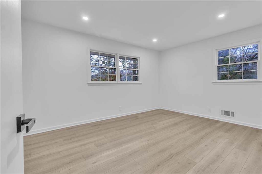 3296 Columbia Woods Drive Decatur, GA 30032 - Photo 20 of 47 an empty room with wooden floor and windows