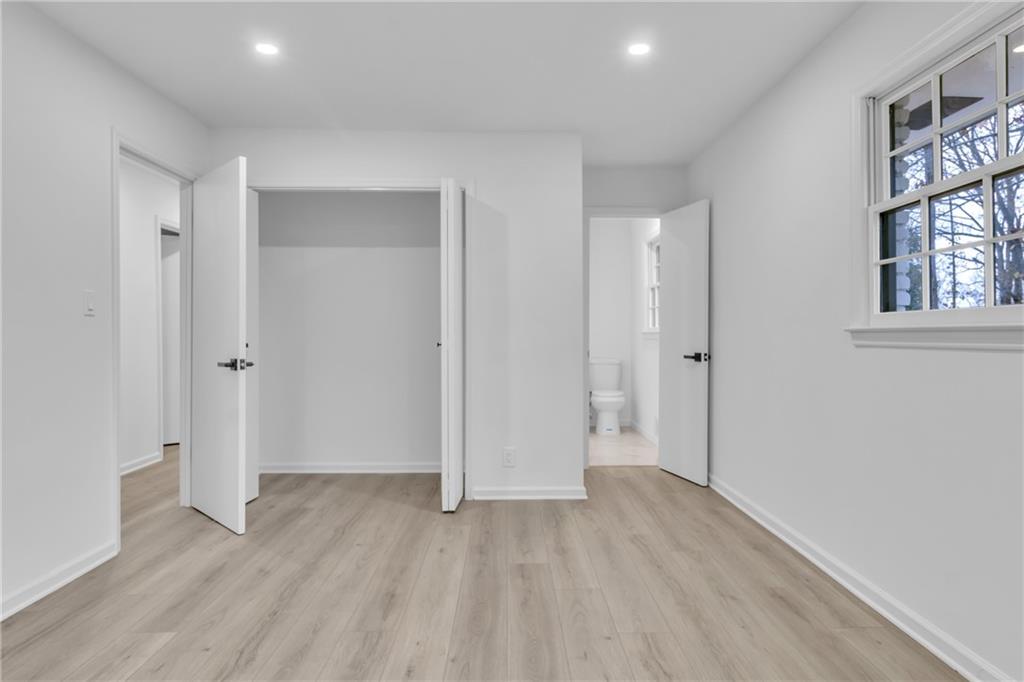 3296 Columbia Woods Drive Decatur, GA 30032 - Photo 21 of 47 an empty room with wooden floor and windows