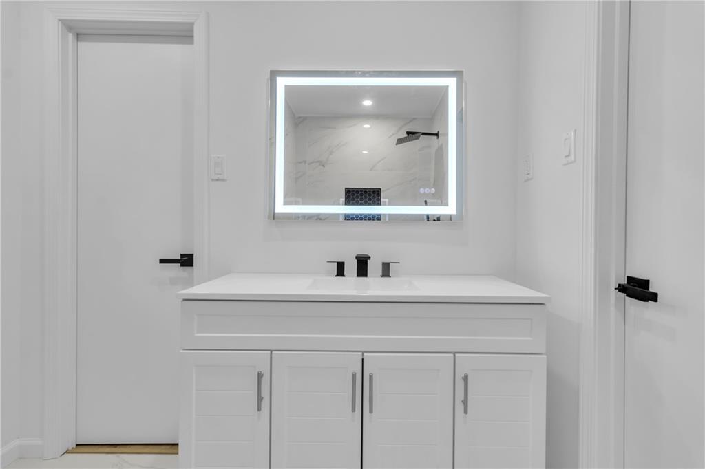 3296 Columbia Woods Drive Decatur, GA 30032 - Photo 24 of 47 a bathroom with a sink and a mirror