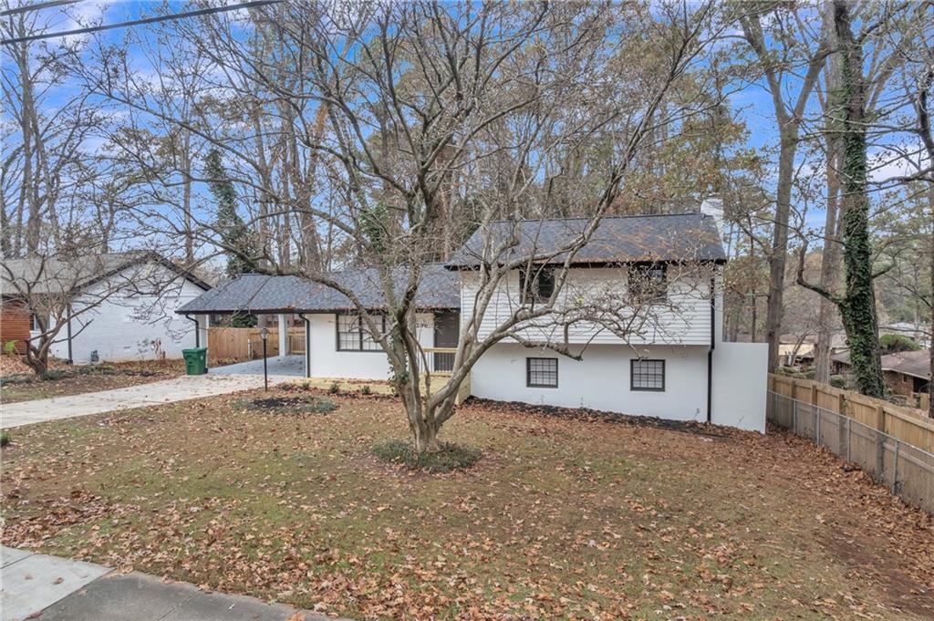 3296 Columbia Woods Drive Decatur, GA 30032 - Photo 3 of 47 a white house that has a tree in front of it