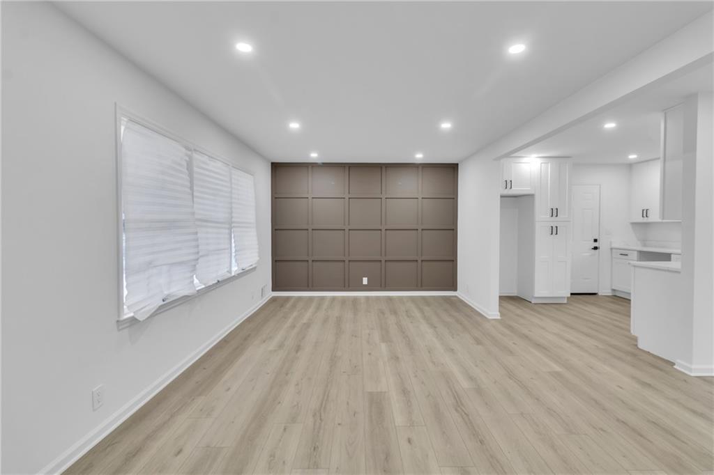 3296 Columbia Woods Drive Decatur, GA 30032 - Photo 8 of 47 an empty room with wooden floor and windows