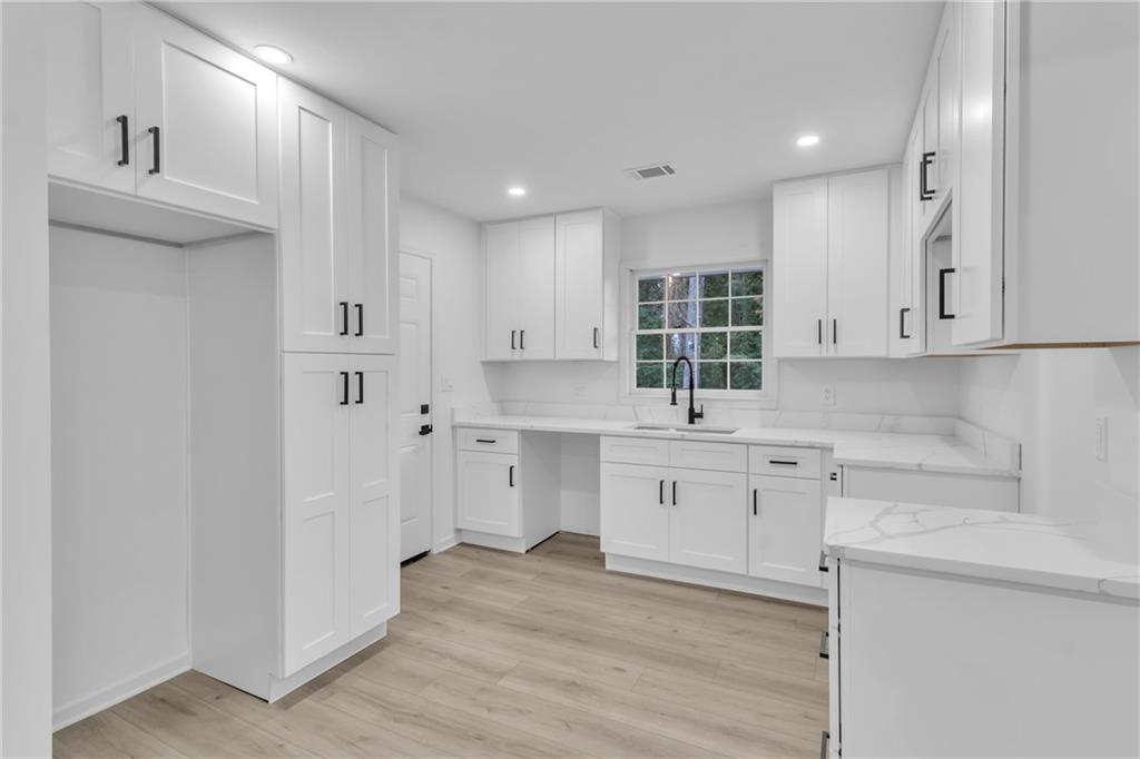 3296 Columbia Woods Drive Decatur, GA 30032 - Photo 10 of 47 a kitchen with white cabinets and sink