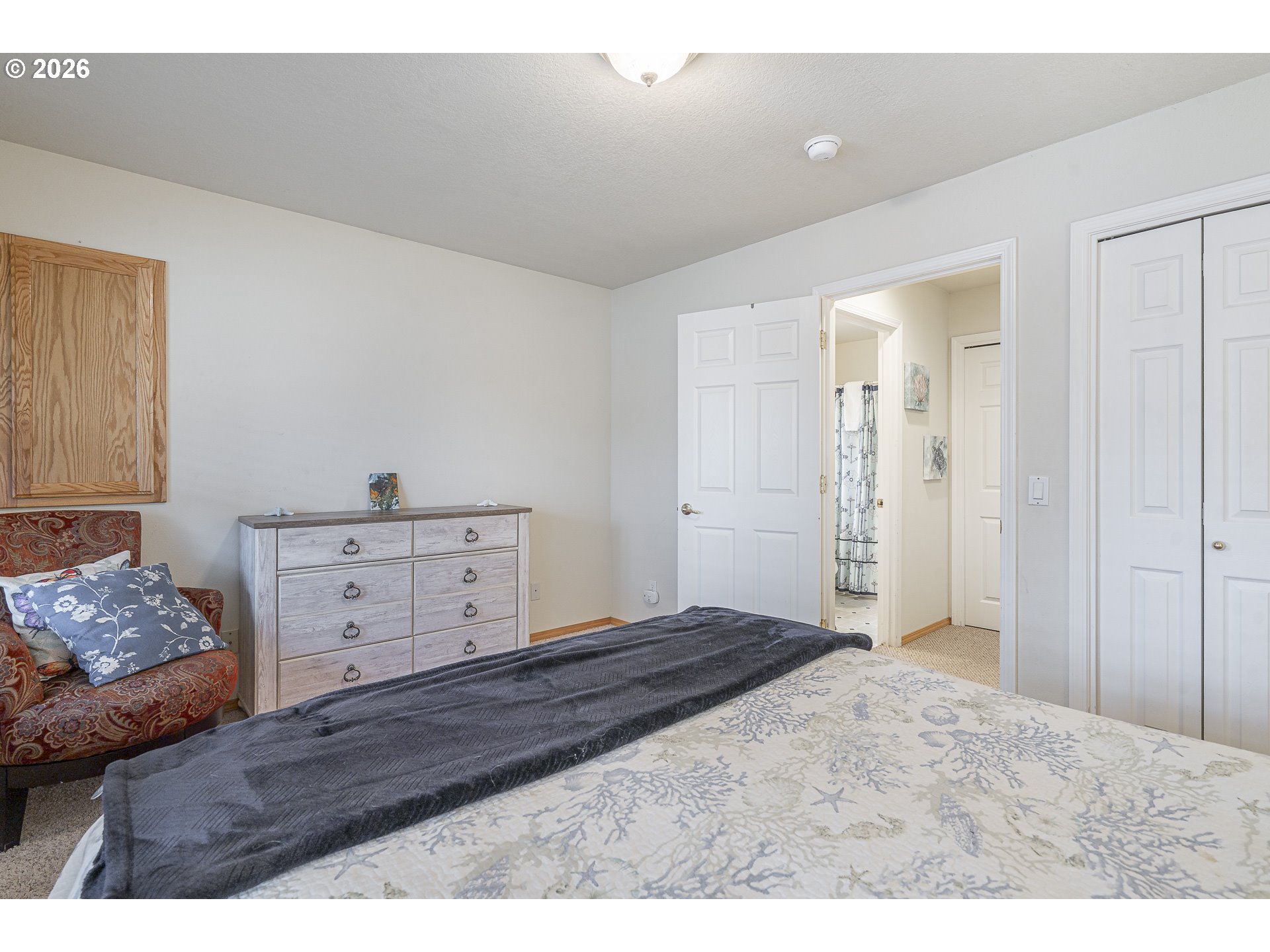 7850 Pine Beach Loop Rockaway Beach, OR 97136 - Photo 17 of 33 a bedroom with a bed and a dresser