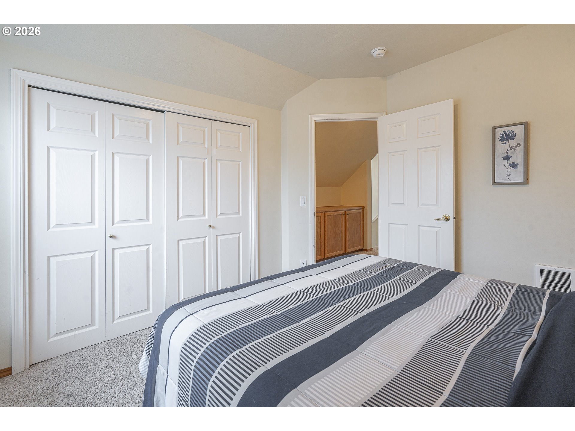7850 Pine Beach Loop Rockaway Beach, OR 97136 - Photo 18 of 33 a bedroom with a bed and a painting