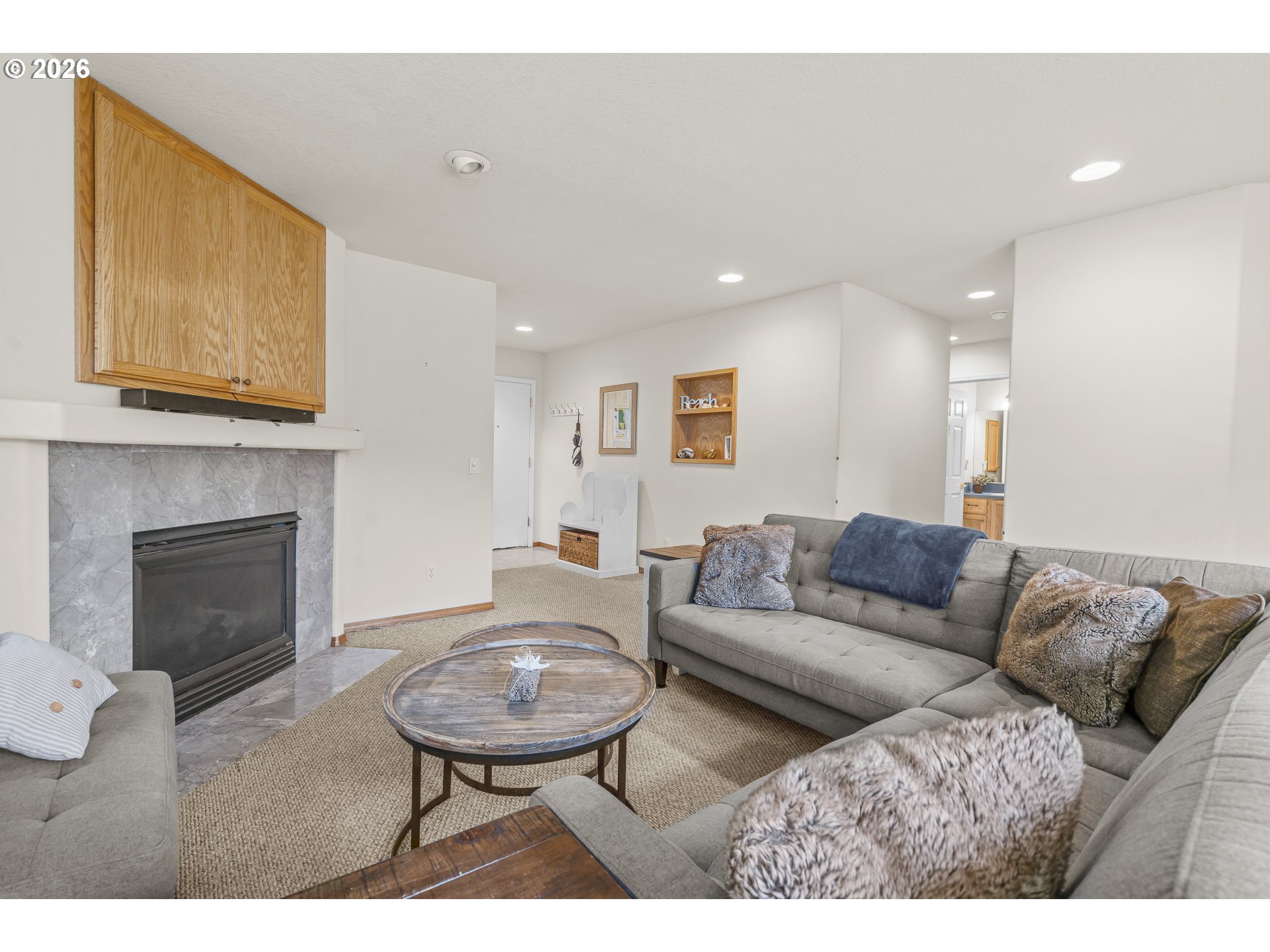 7850 Pine Beach Loop Rockaway Beach, OR 97136 - Photo 4 of 33 a living room with furniture a fireplace and a wooden floor