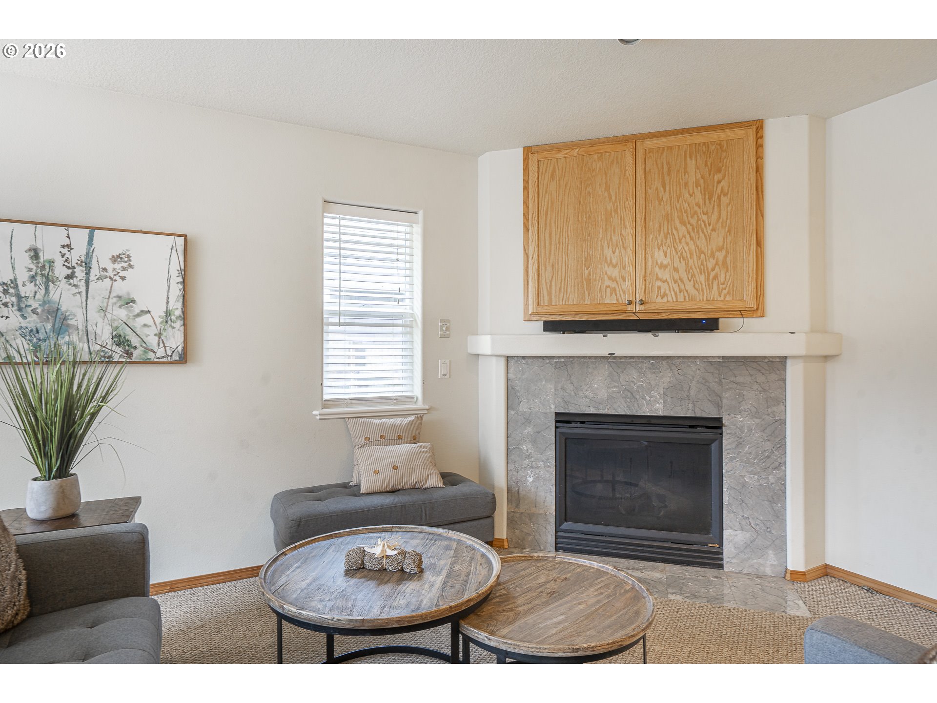 7850 Pine Beach Loop Rockaway Beach, OR 97136 - Photo 5 of 33 a living room with furniture a fireplace and a potted plant