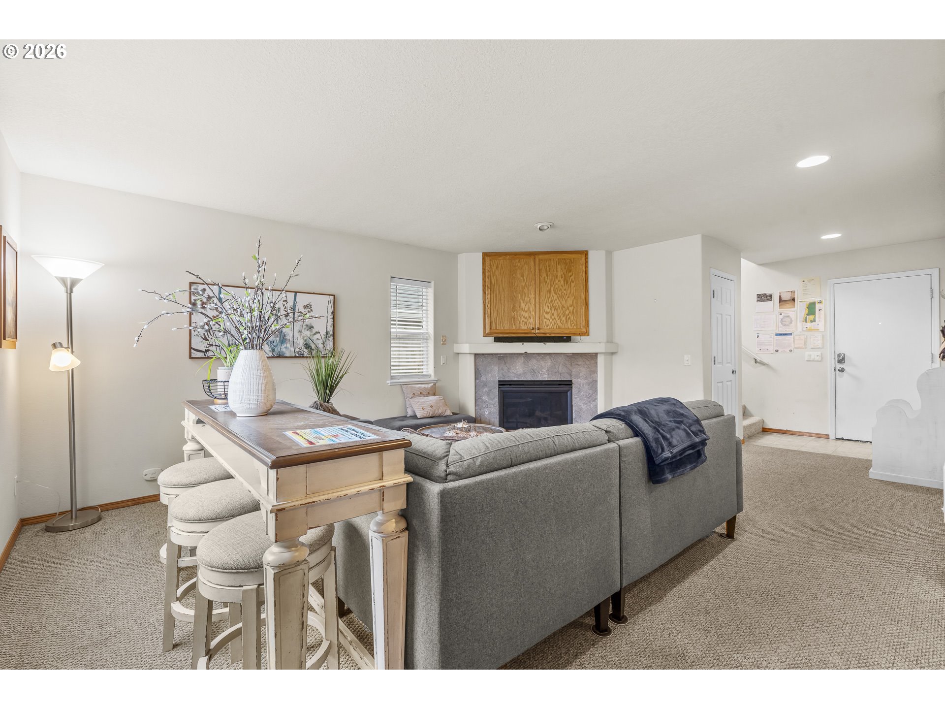 7850 Pine Beach Loop Rockaway Beach, OR 97136 - Photo 6 of 33 a living room with furniture a fireplace and a flat screen tv