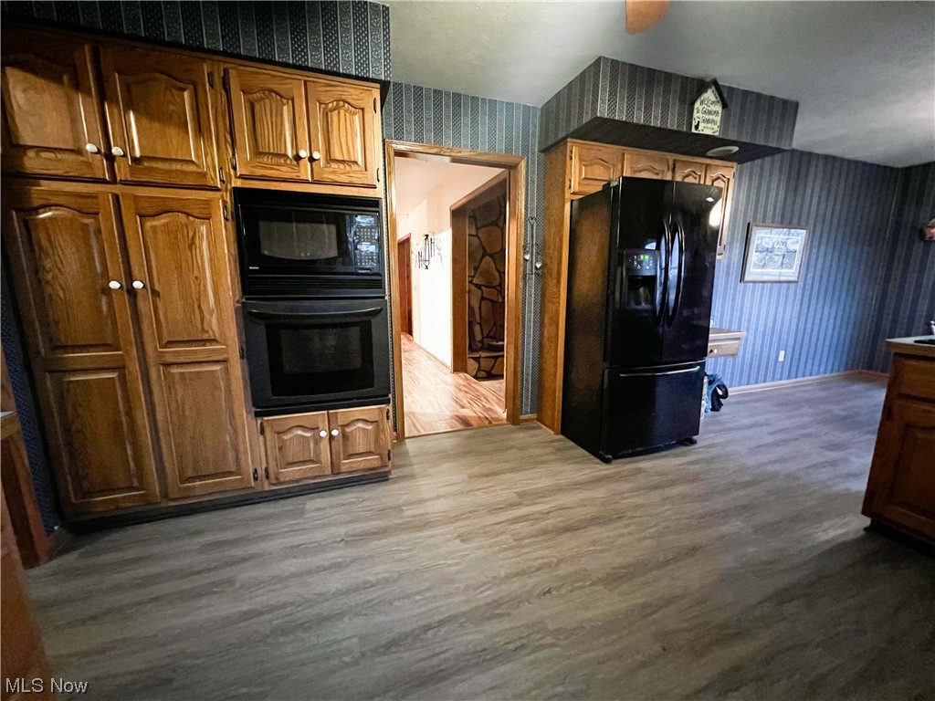 10263 Cemetery Road Burbank, OH 44214 - Photo 5 of 22 Kitchen featuring black appliances and hardwood / wood-style flooring