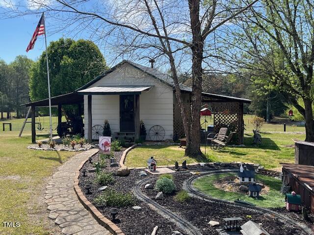 663 Fleming Road Coats, NC 27521 - Photo 15 of 42 a view of a house with swimming pool and a small yard