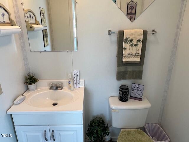 663 Fleming Road Coats, NC 27521 - Photo 18 of 42 a bathroom with a toilet sink and mirror