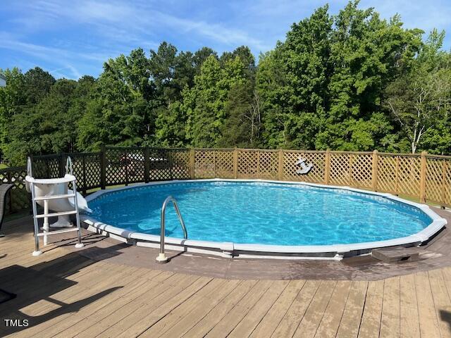 663 Fleming Road Coats, NC 27521 - Photo 32 of 42 a view of a swimming pool with a patio and a yard