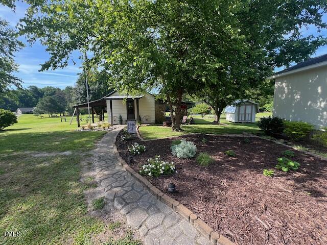 663 Fleming Road Coats, NC 27521 - Photo 39 of 42 a front view of a house with garden