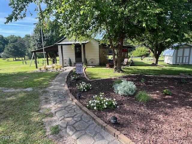 663 Fleming Road Coats, NC 27521 - Photo 40 of 42 a front view of a house with garden
