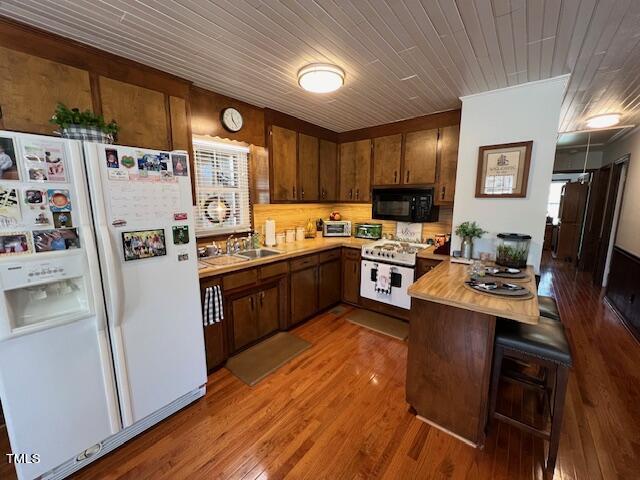 663 Fleming Road Coats, NC 27521 - Photo 5 of 42 a kitchen with stainless steel appliances a stove a refrigerator a sink a oven with wooden floor and cabinets
