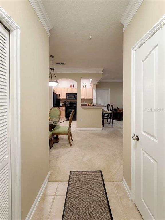 12843 Madison Pointe Circle, Unit 107 Orlando, FL 32821 - Photo 12 of 26 a living room with furniture and a table