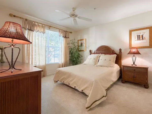 a bedroom with a bed dresser and a window