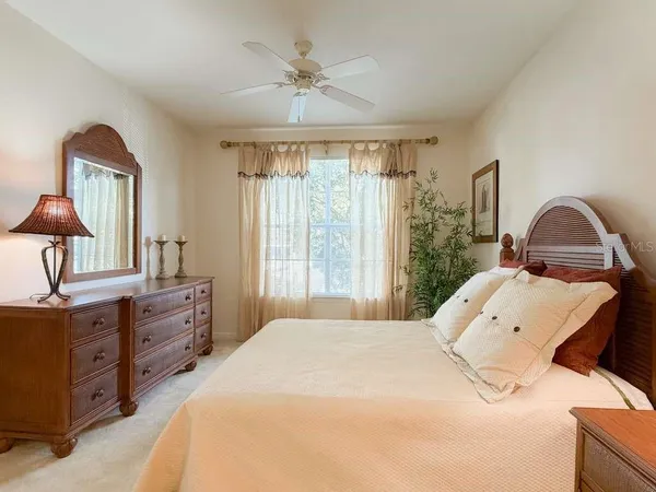 a bedroom with a large bed and a chandelier