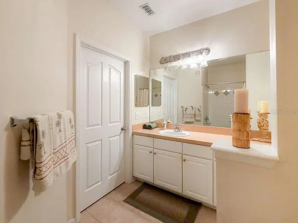 a spacious bathroom with a granite countertop sink and a mirror