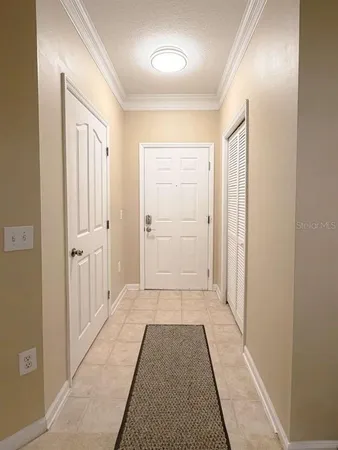 a view of a hallway with wooden floor and closet