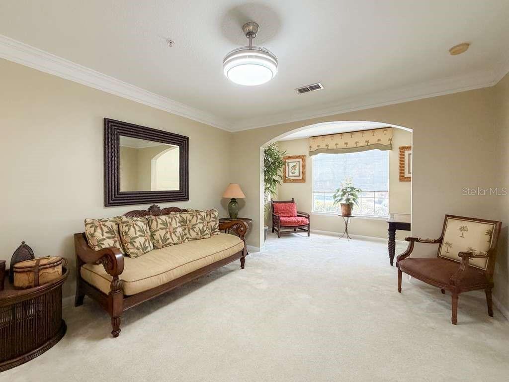 12843 Madison Pointe Circle, Unit 107 Orlando, FL 32821 - Photo 2 of 26 a living room with furniture and a large window