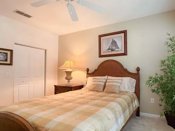 a bedroom with a bed and a painting on the wall
