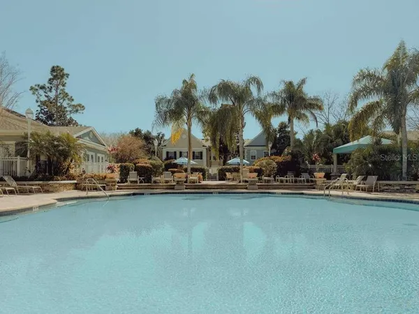 a view of swimming pool with outdoor seating and a garden
