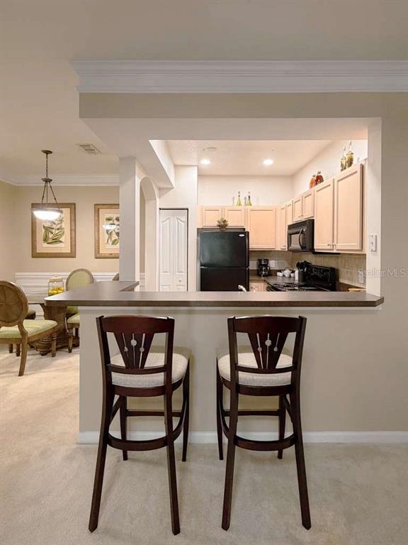 12843 Madison Pointe Circle, Unit 107 Orlando, FL 32821 - Photo 6 of 26 a kitchen with a table and chairs in it