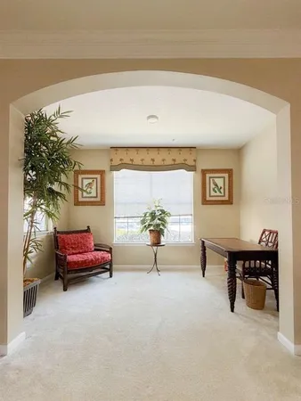 a living room with furniture and a potted plant