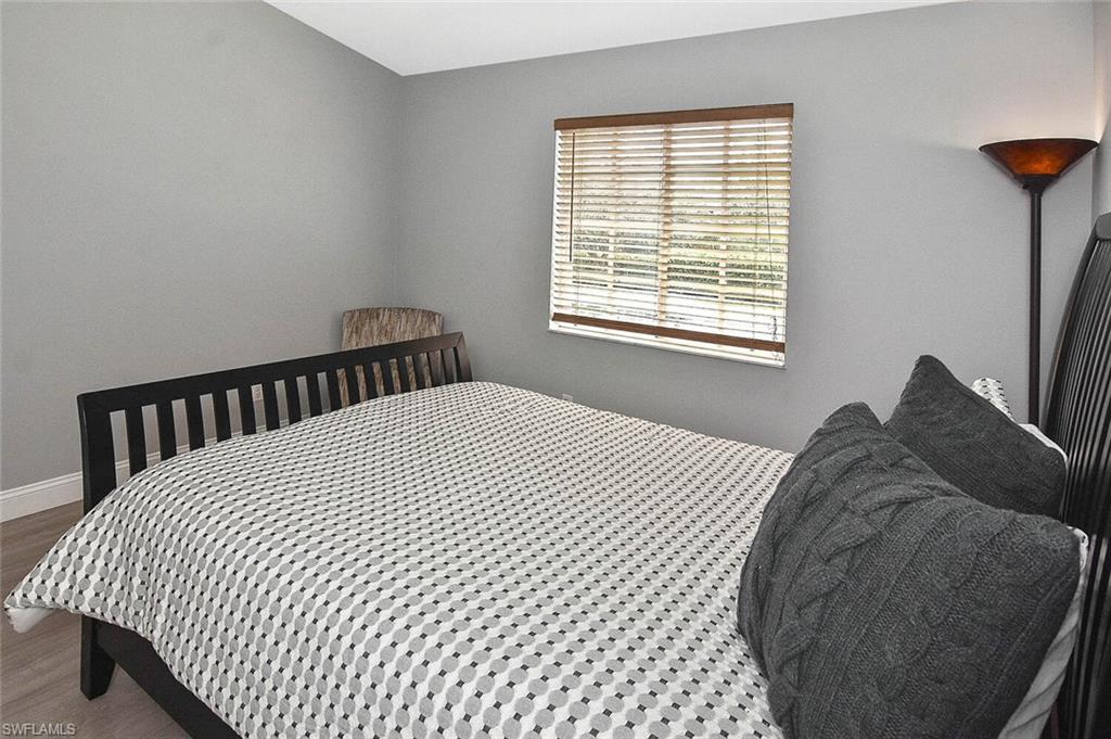 8075 Tiger Cove, Unit 1711 Naples, FL 34113 - Photo 12 of 42 a bedroom with a bed and a window