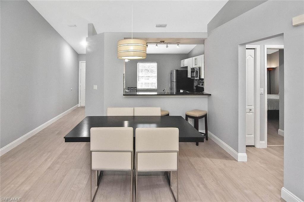 8075 Tiger Cove, Unit 1711 Naples, FL 34113 - Photo 16 of 42 a living room with furniture and a wooden floor
