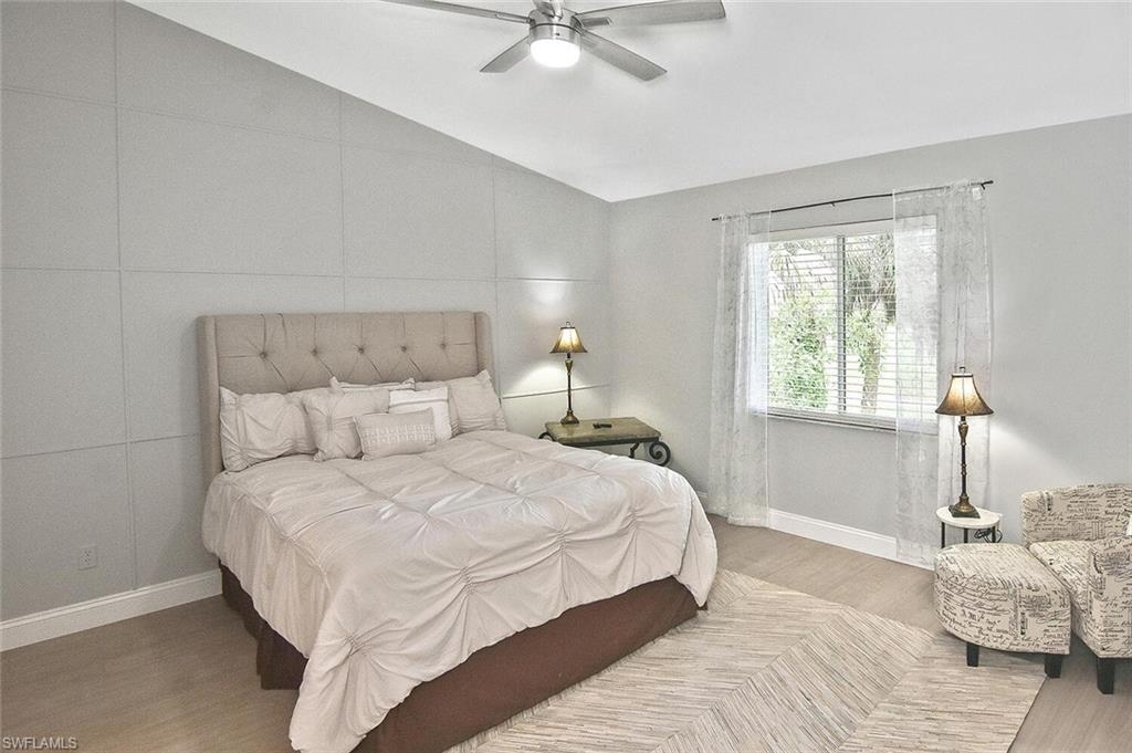 8075 Tiger Cove, Unit 1711 Naples, FL 34113 - Photo 26 of 42 a bedroom with a bed and window