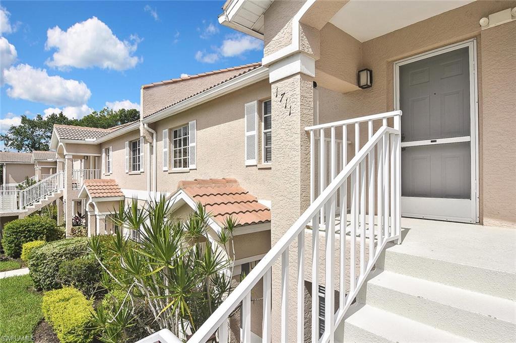 8075 Tiger Cove, Unit 1711 Naples, FL 34113 - Photo 3 of 42 a view of a house with backyard and deck
