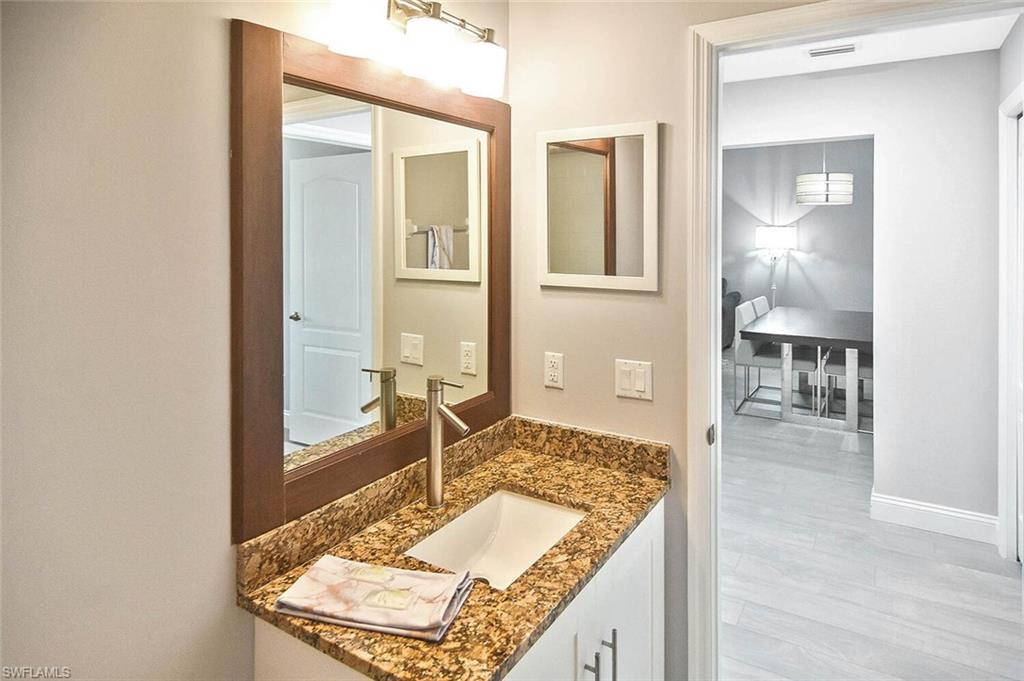 8075 Tiger Cove, Unit 1711 Naples, FL 34113 - Photo 10 of 42 a view of a bathroom with sink and mirror