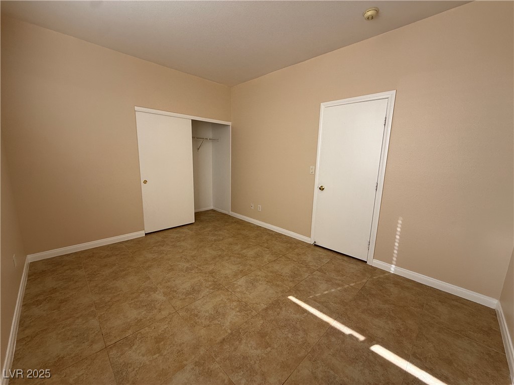 9950 Shadow Grove Avenue Las Vegas, NV 89148 - Photo 15 of 37 Unfurnished bedroom with baseboards and a closet