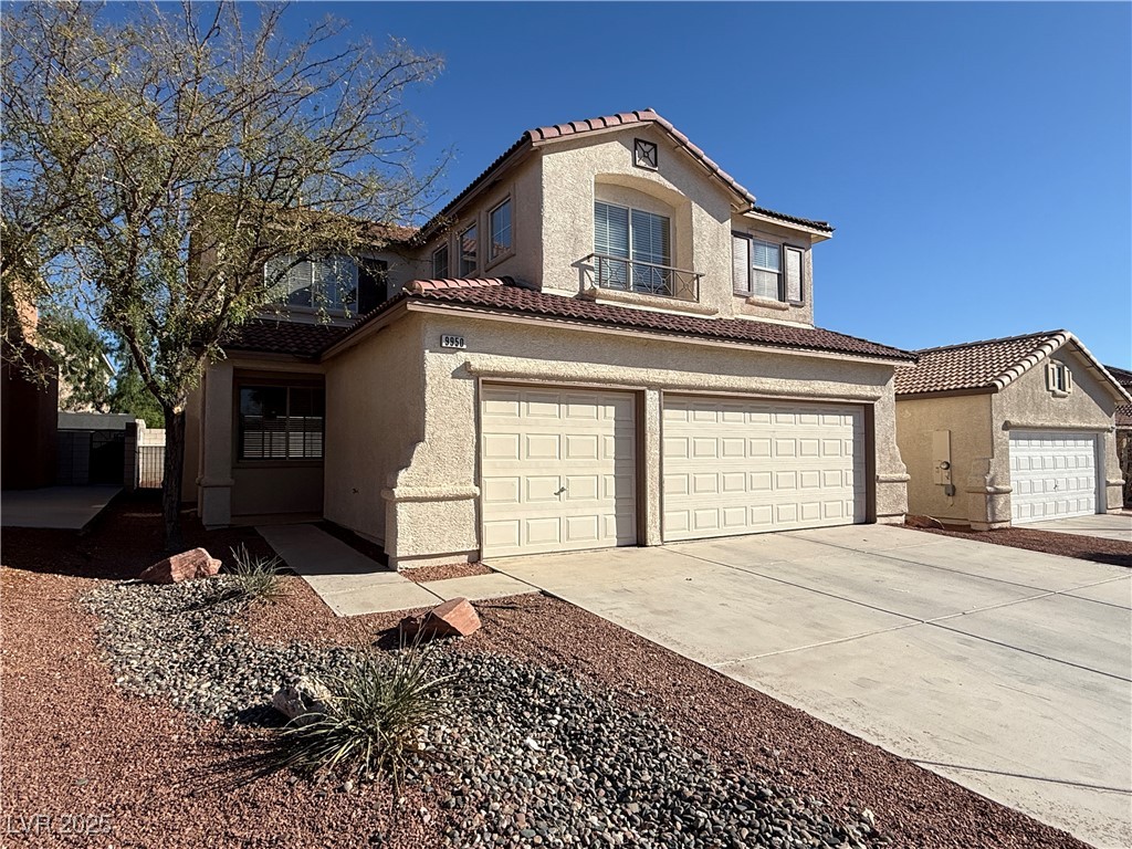 9950 Shadow Grove Avenue Las Vegas, NV 89148 - Photo 2 of 37 Mediterranean / spanish-style house with a tile roof, driveway, stucco siding, and a garage