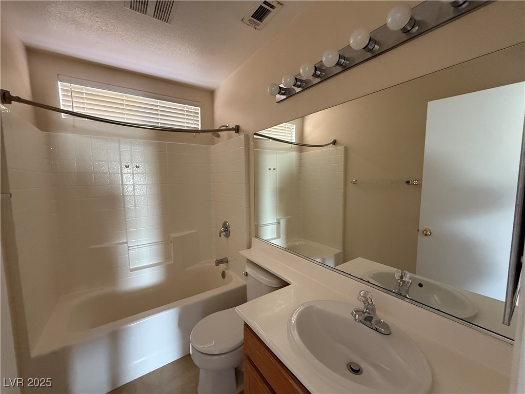 9950 Shadow Grove Avenue Las Vegas, NV 89148 - Photo 27 of 37 Bathroom featuring shower / bathtub combination, vanity, and a textured ceiling