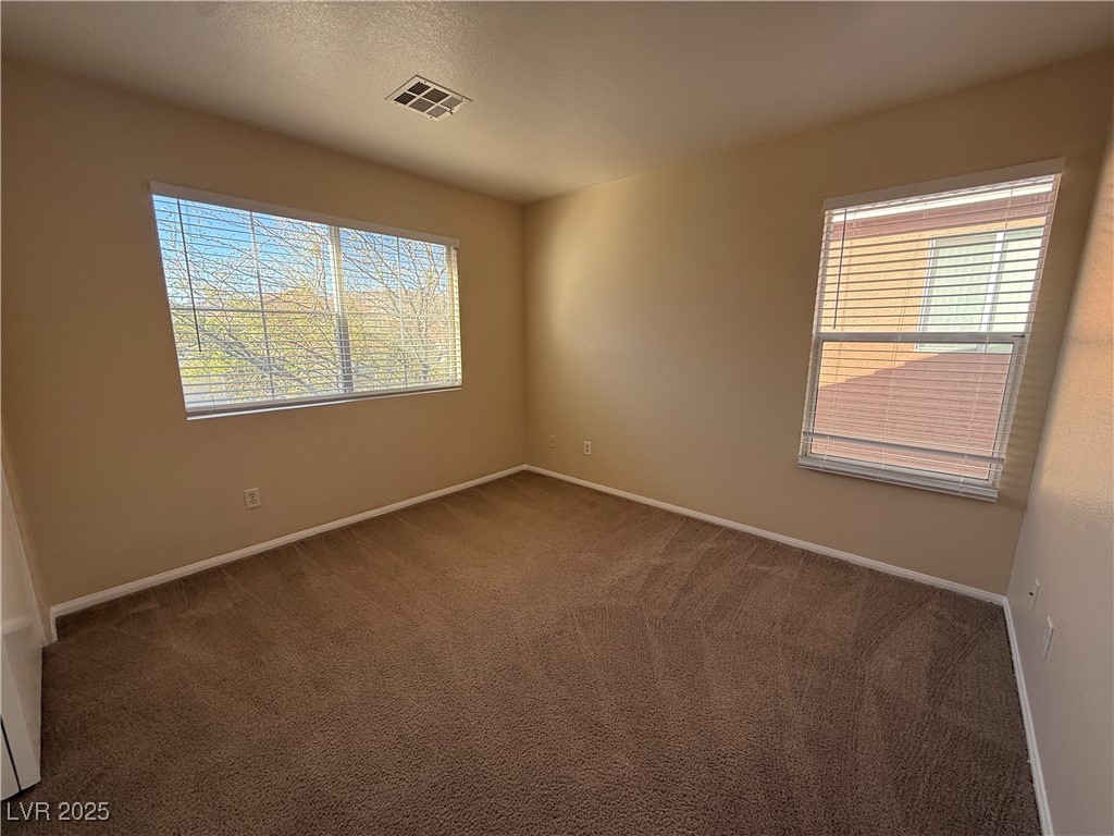 9950 Shadow Grove Avenue Las Vegas, NV 89148 - Photo 28 of 37 Carpeted empty room featuring baseboards and a textured ceiling
