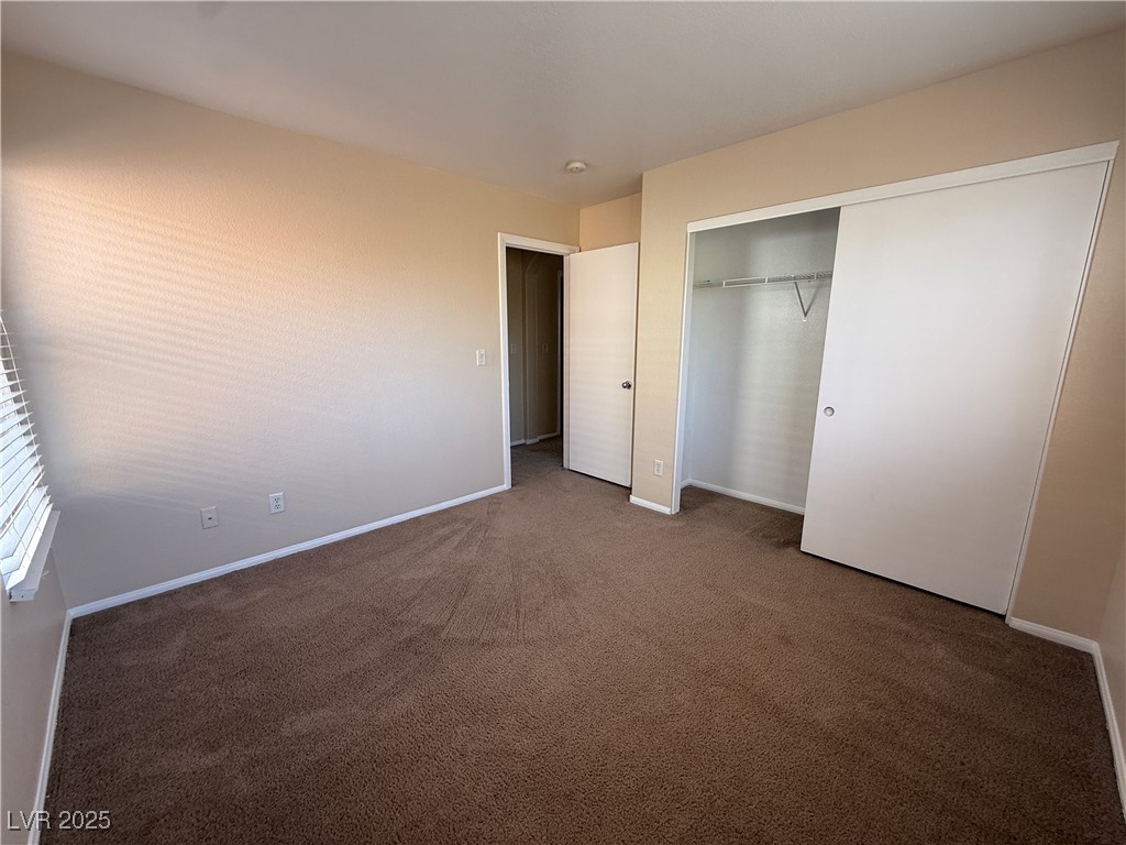 9950 Shadow Grove Avenue Las Vegas, NV 89148 - Photo 30 of 37 Unfurnished bedroom with a closet and dark carpet