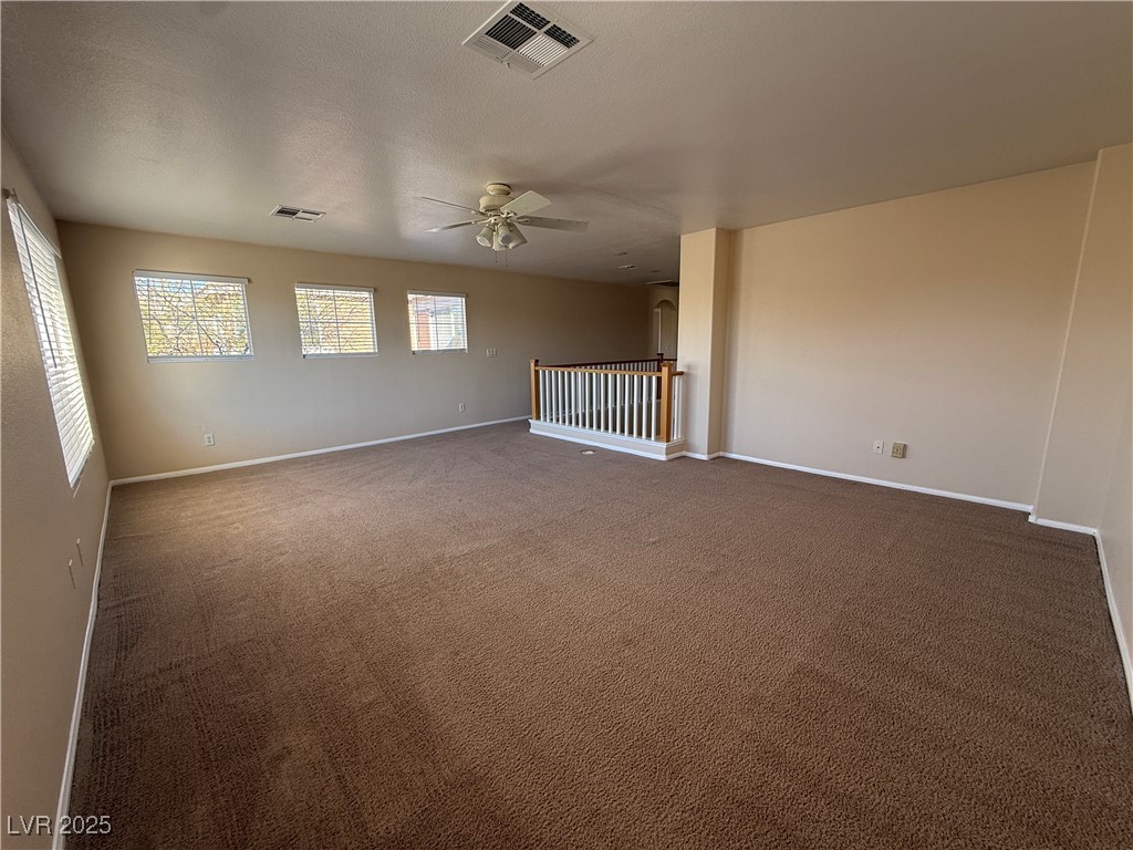9950 Shadow Grove Avenue Las Vegas, NV 89148 - Photo 31 of 37 Empty room featuring carpet floors, a textured ceiling, and ceiling fan