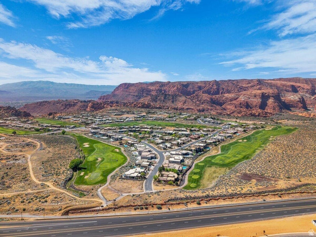 5010 Escapes Drive St. George, UT 84770 - Photo 41 of 46 View of mountain backdrop with a golf course and nearby suburban area