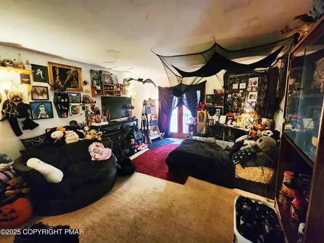 a bedroom with bed and a mirror