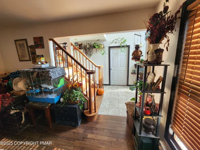 a view of a livingroom with furniture a flat screen tv and a large window